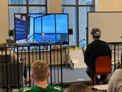 Paul Hillman wearing a headset providing a demonstration in a classroom.